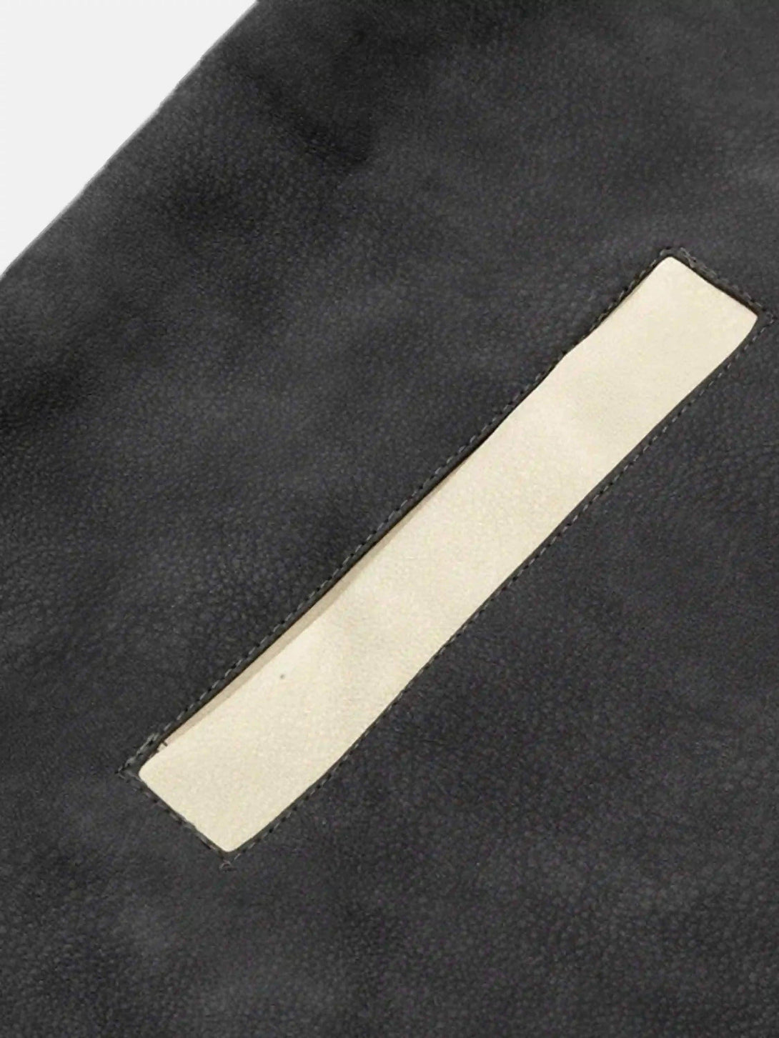 A detailed view of the hip-hop motorcycle trend jacket's pocket design by TALISHKO.