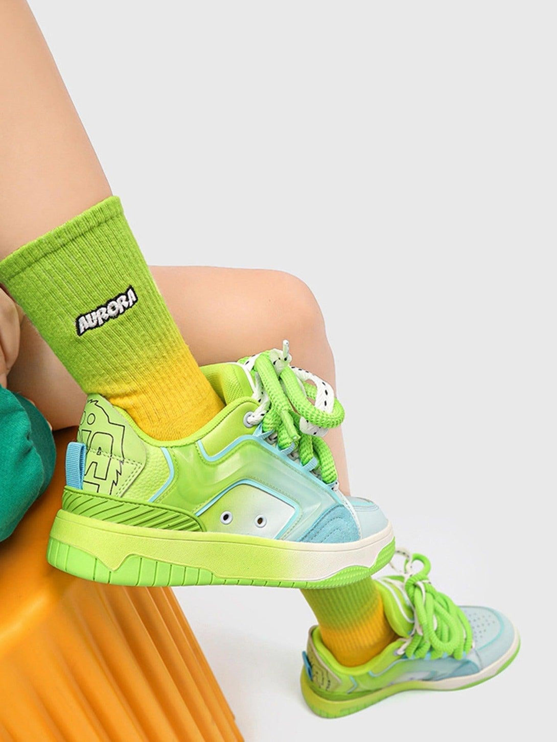 Lime and blue TALISHKO skateboard shoes paired with green socks, highlighting hip-hop flair.