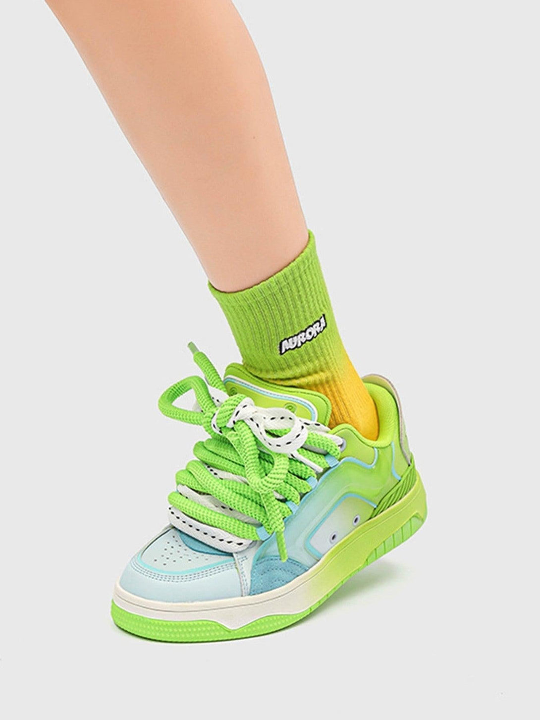 A vibrant look with TALISHKO hip-hop skateboard shoes in green and blue, paired with yellow socks.