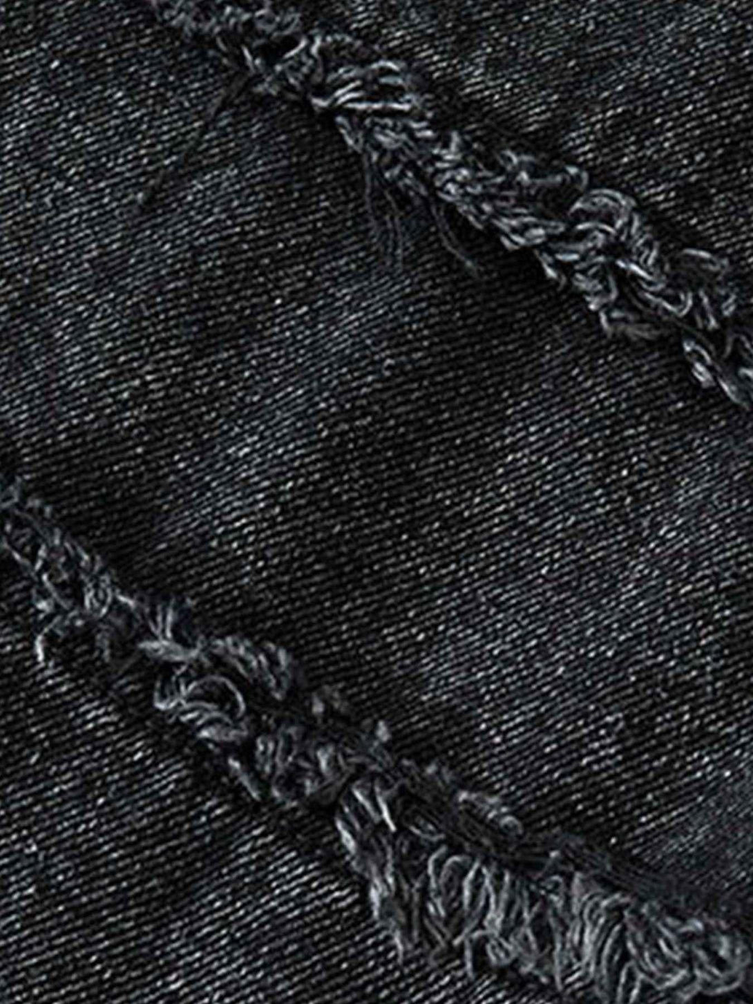A tight crop highlighting TALISHKO's retro wash denim texture and intricate stitching.