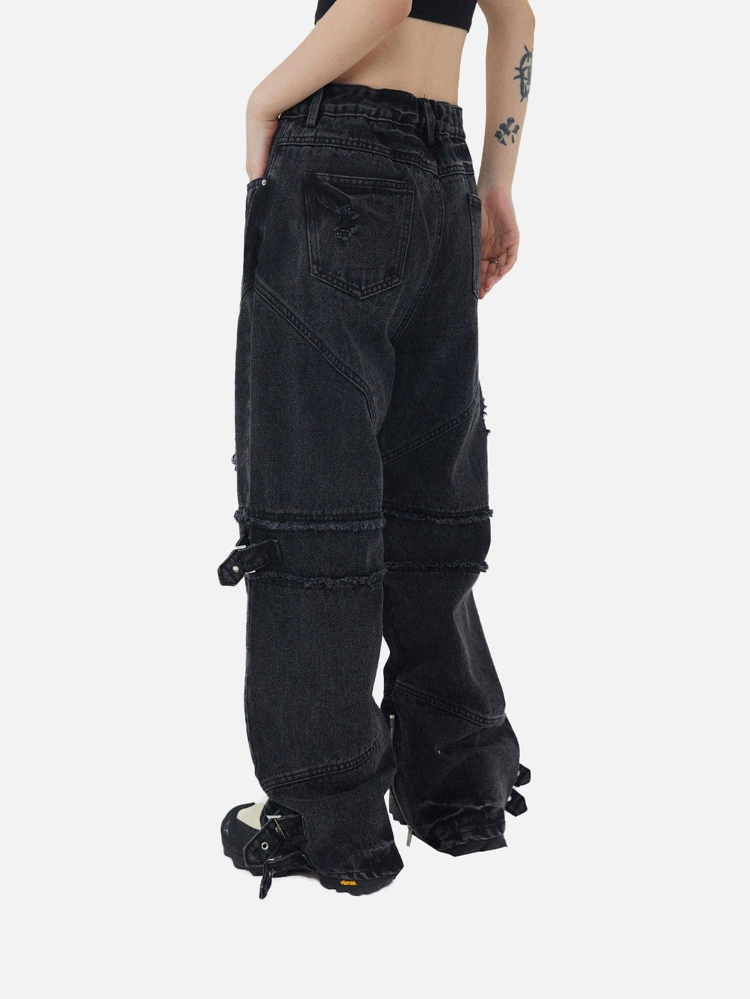 Back view of TALISHKO hip-hop retro denim pants with unique buckle details and relaxed fit.
