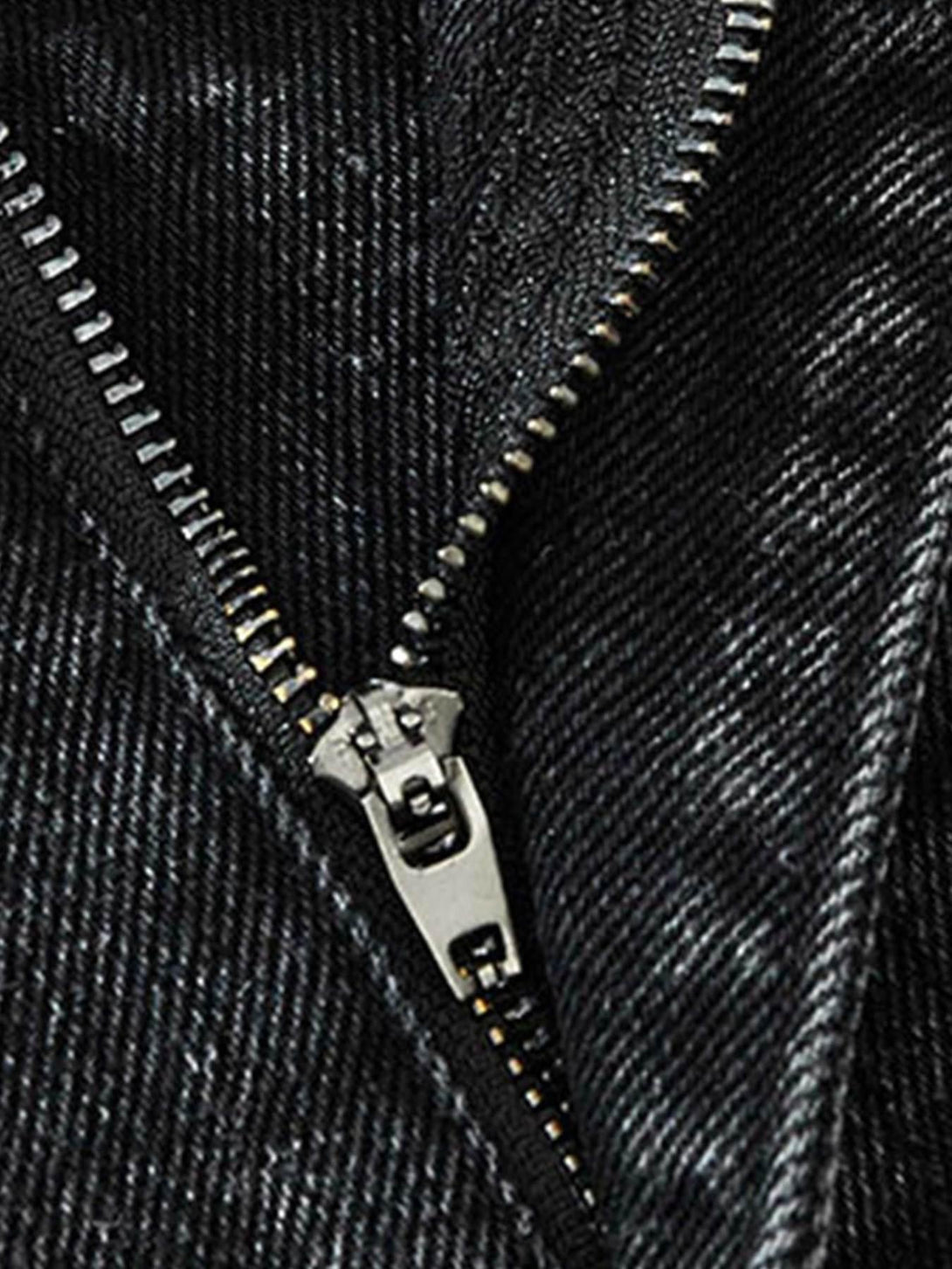 A detailed look at the TALISHKO denim pants zipper, showcasing the retro wash texture.