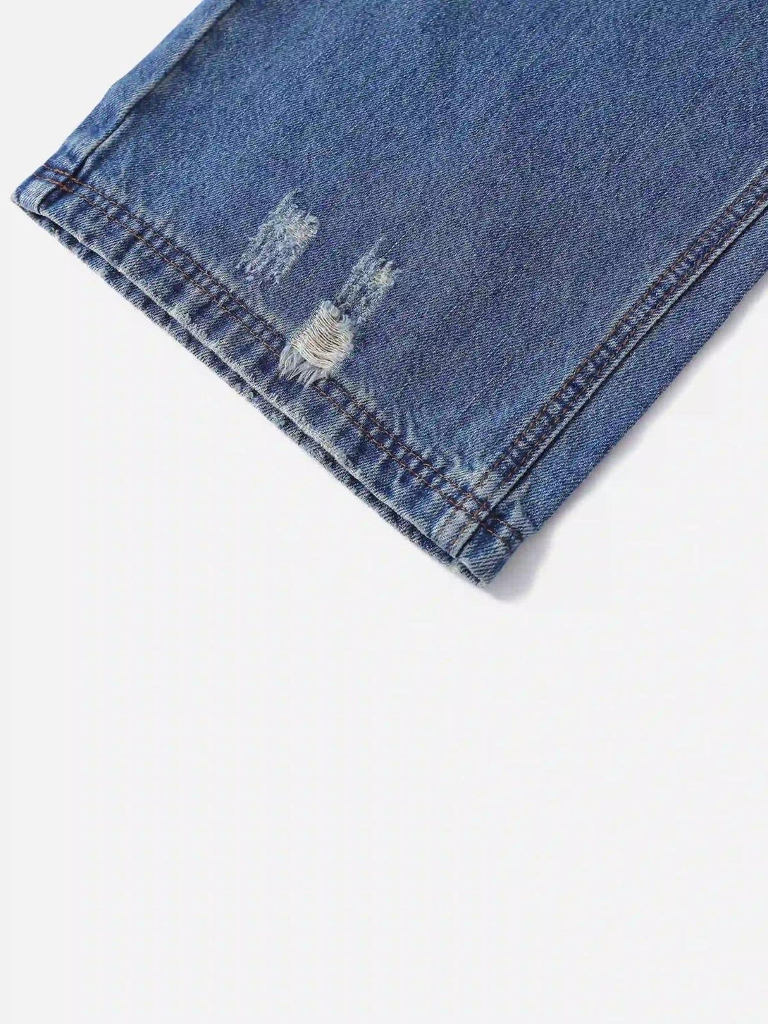 A tight crop highlighting the distressed hem of TALISHKO hip-hop ripped jeans.