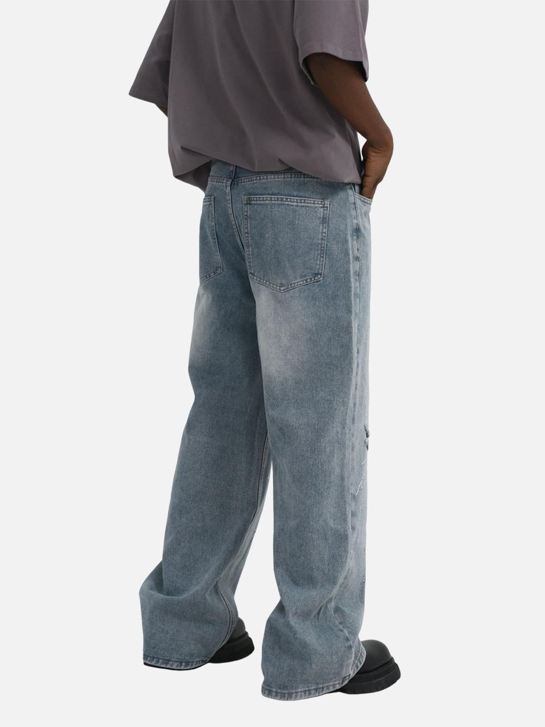 Back view of TALISHKO baggy jeans featuring distressed wash and casual streetwear style.