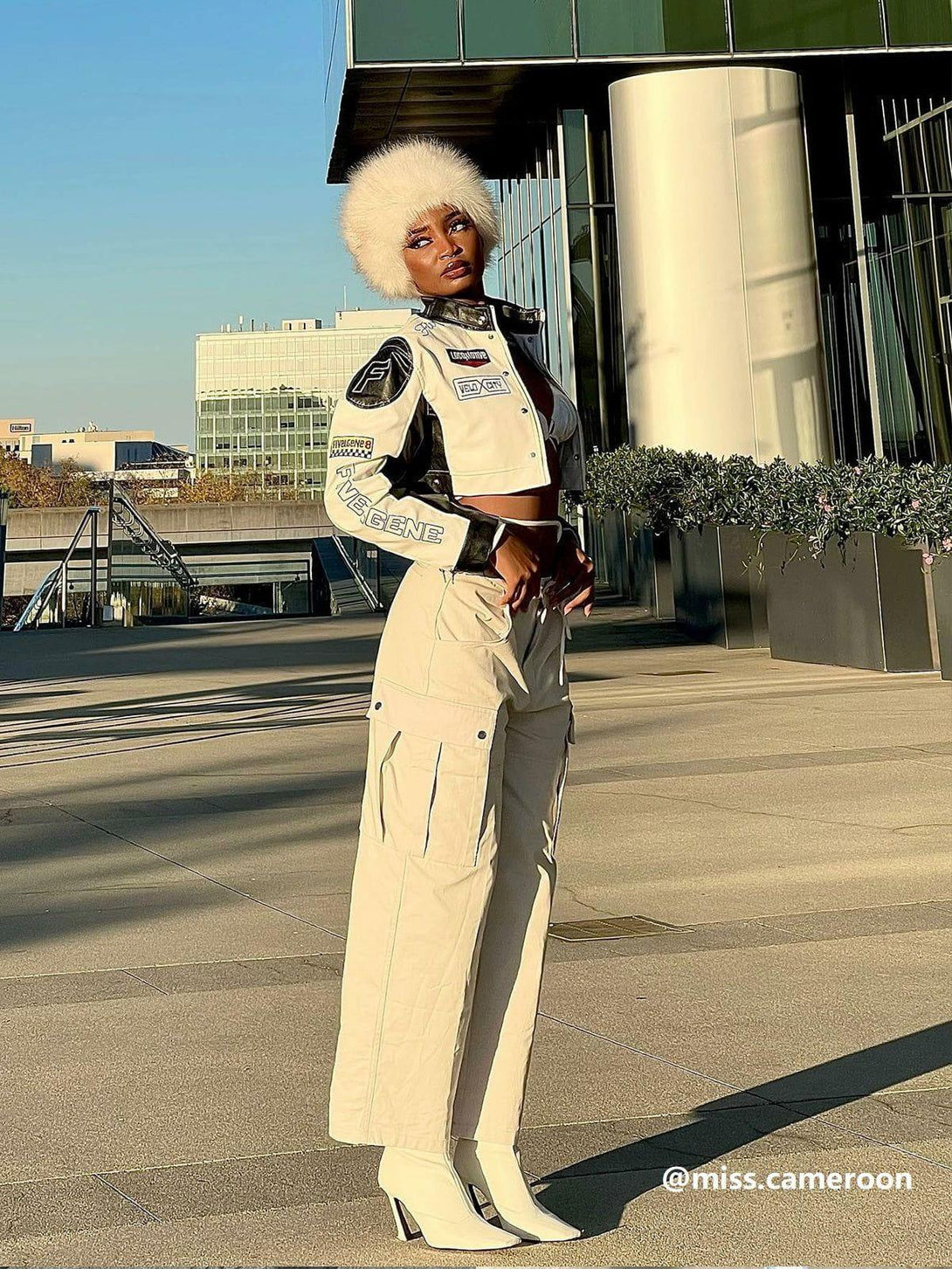 Model wearing TALISHKO cargo pants with a cropped jacket and white boots, exuding urban flair.