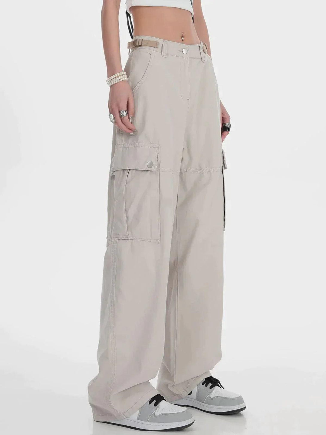 Model in TALISHKO hip hop straight cargo pants, paired with sneakers and a cropped top.