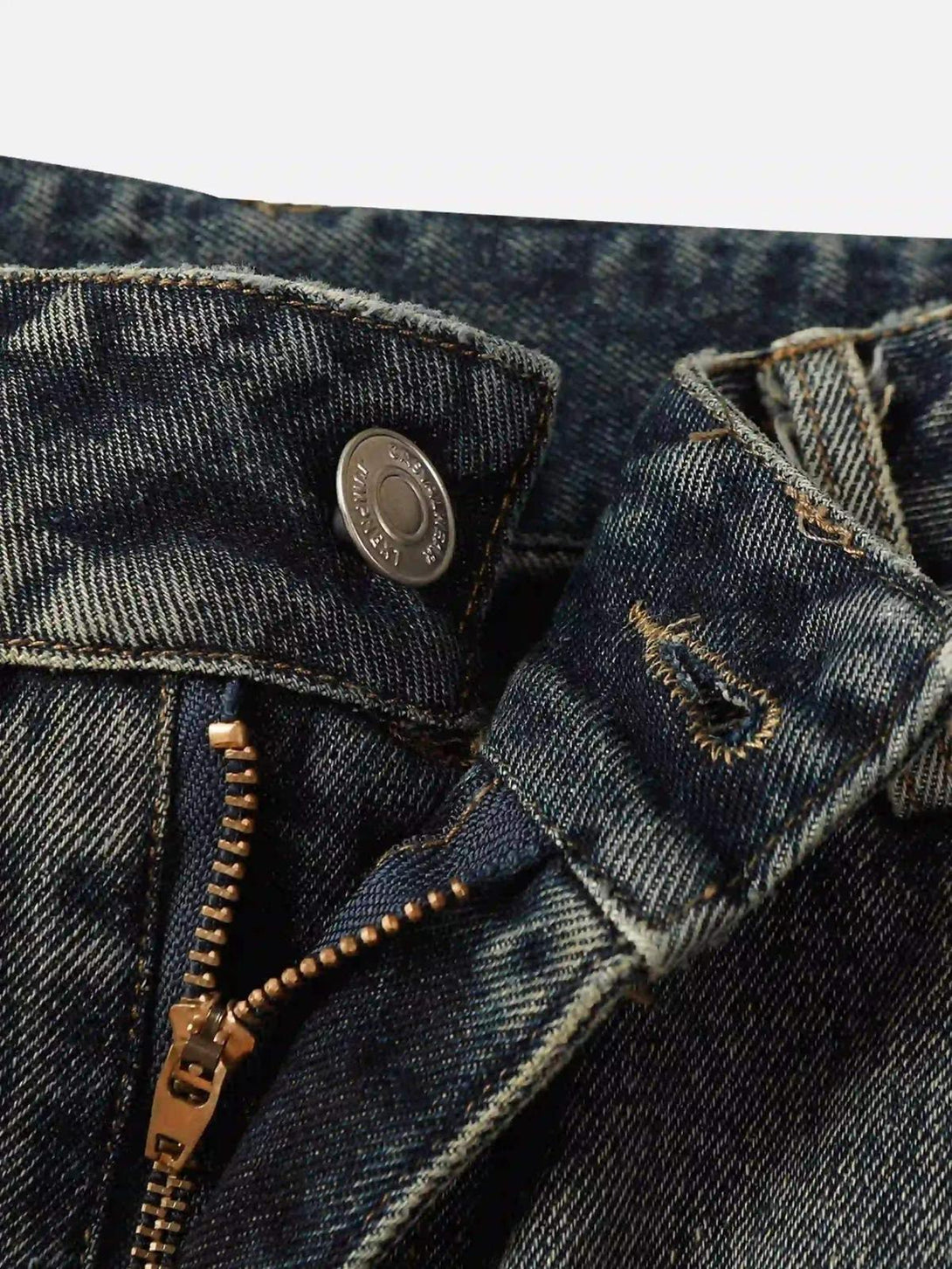 Intricate look at TALISHKO graffiti jeans, highlighting the button and zipper details.