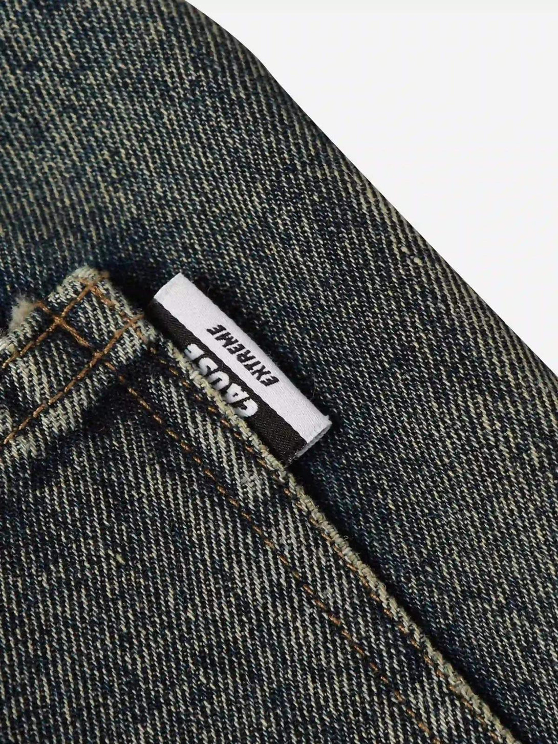 Detailed fabric and stitching of TALISHKO graffiti jeans, showcasing urban style elements.
