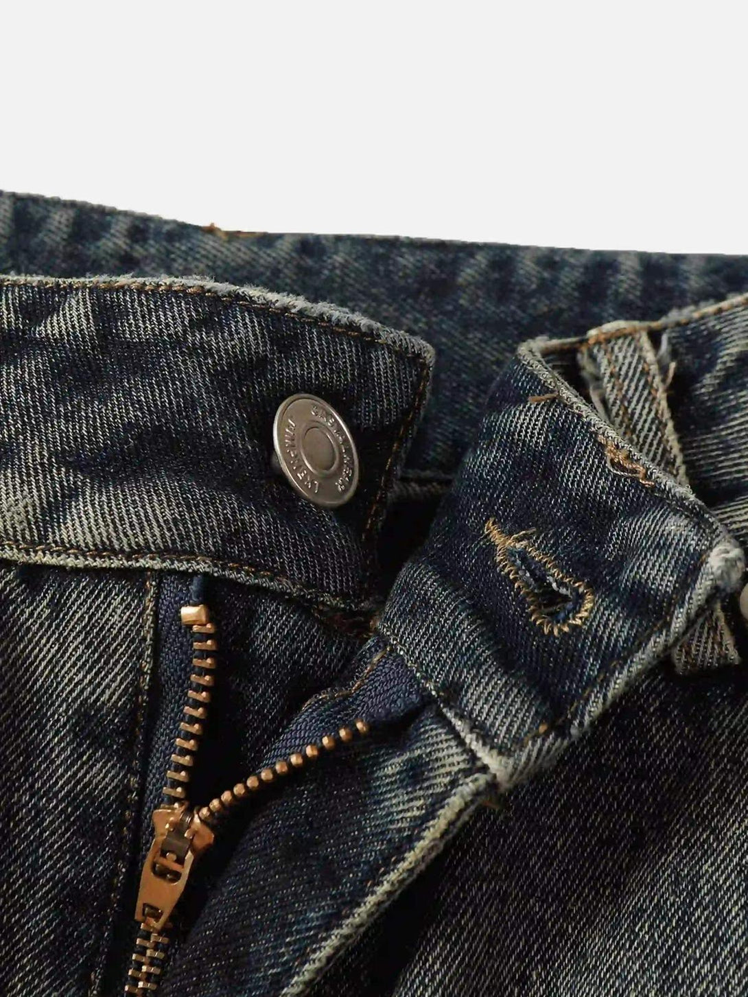 A detailed look at TALISHKO graffiti jeans, highlighting the button and zipper design.