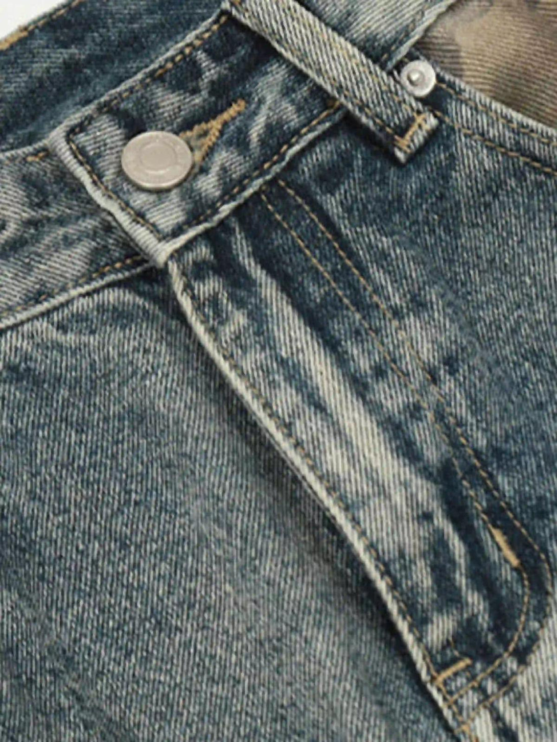 A detailed view of TALISHKO's hip hop jeans, highlighting rugged denim texture and stitching.