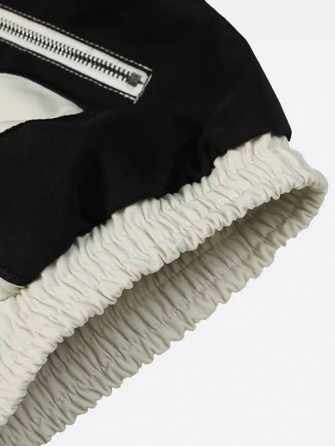 Intricate look at the elastic cuff and zipper of a TALISHKO jacket, highlighting craftsmanship.