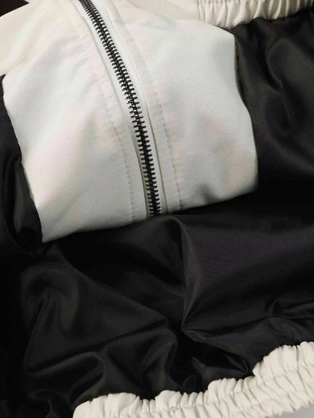 Intricate look at the zipper and fabric details of a TALISHKO jacket, highlighting its craftsmanship.