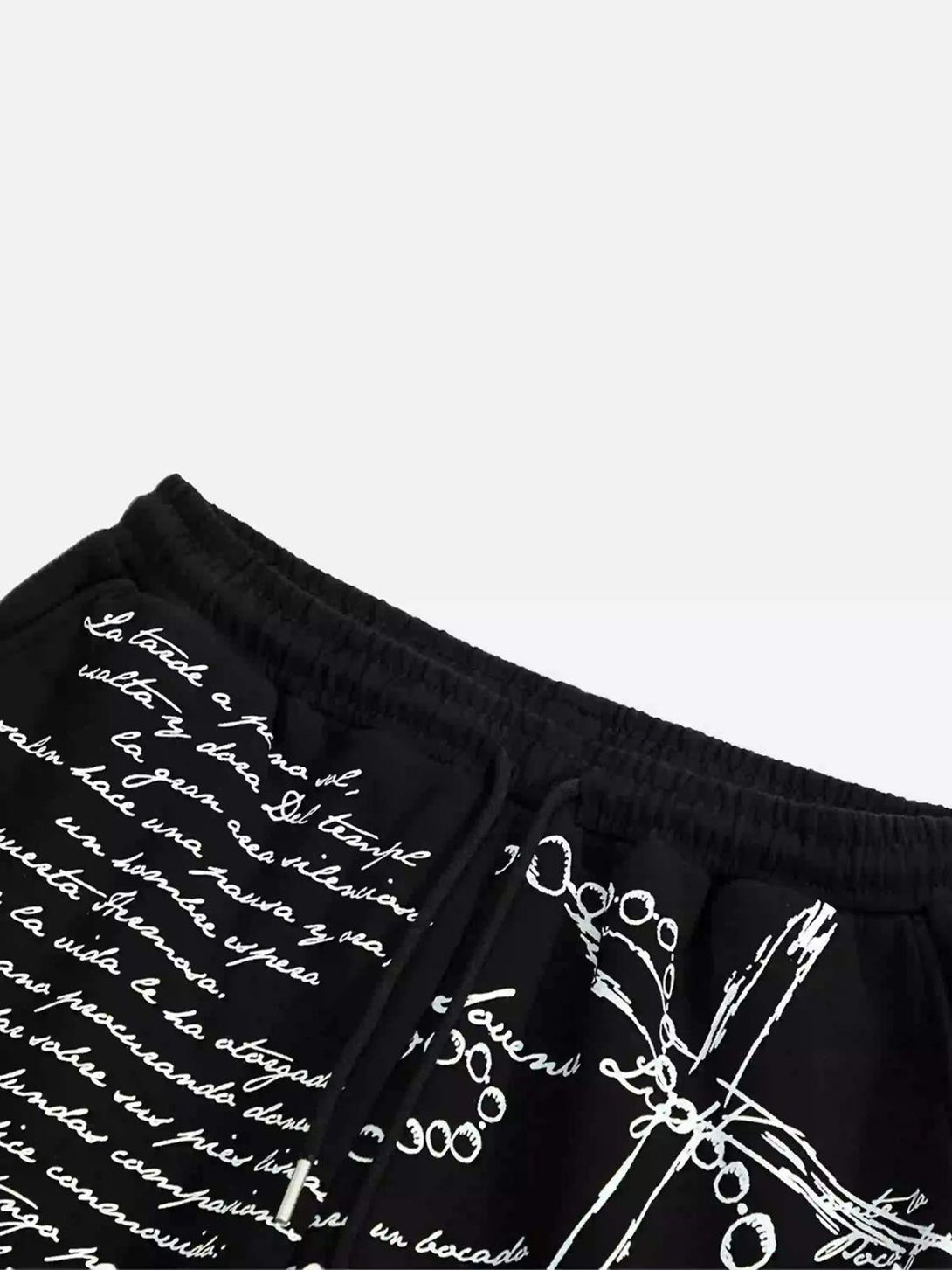 Intricate details on TALISHKO hip-hop pants, highlighting expressive script and cross design.