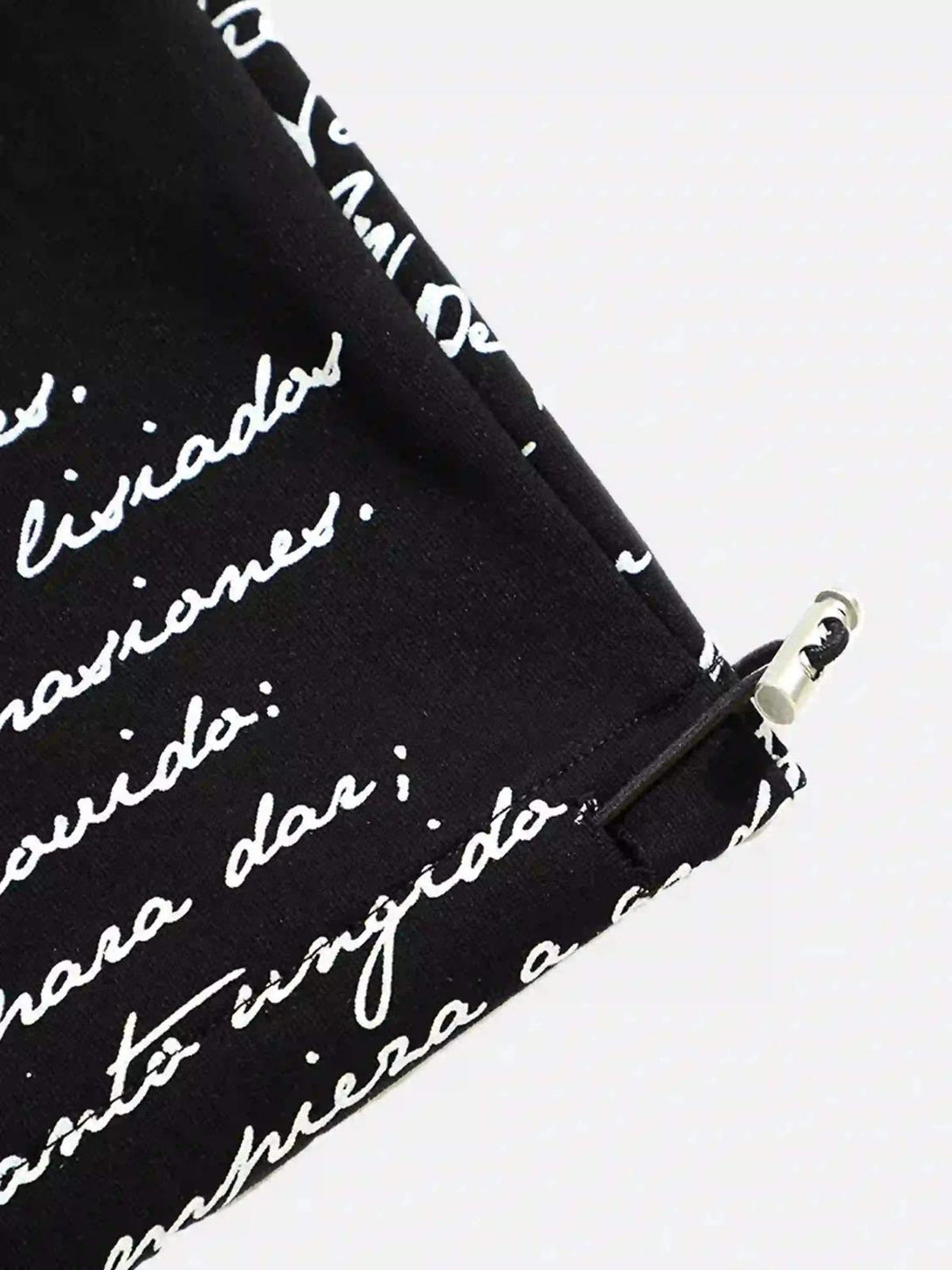 Detailed view of TALISHKO hip-hop pants, highlighting expressive script design and drawstring detail.
