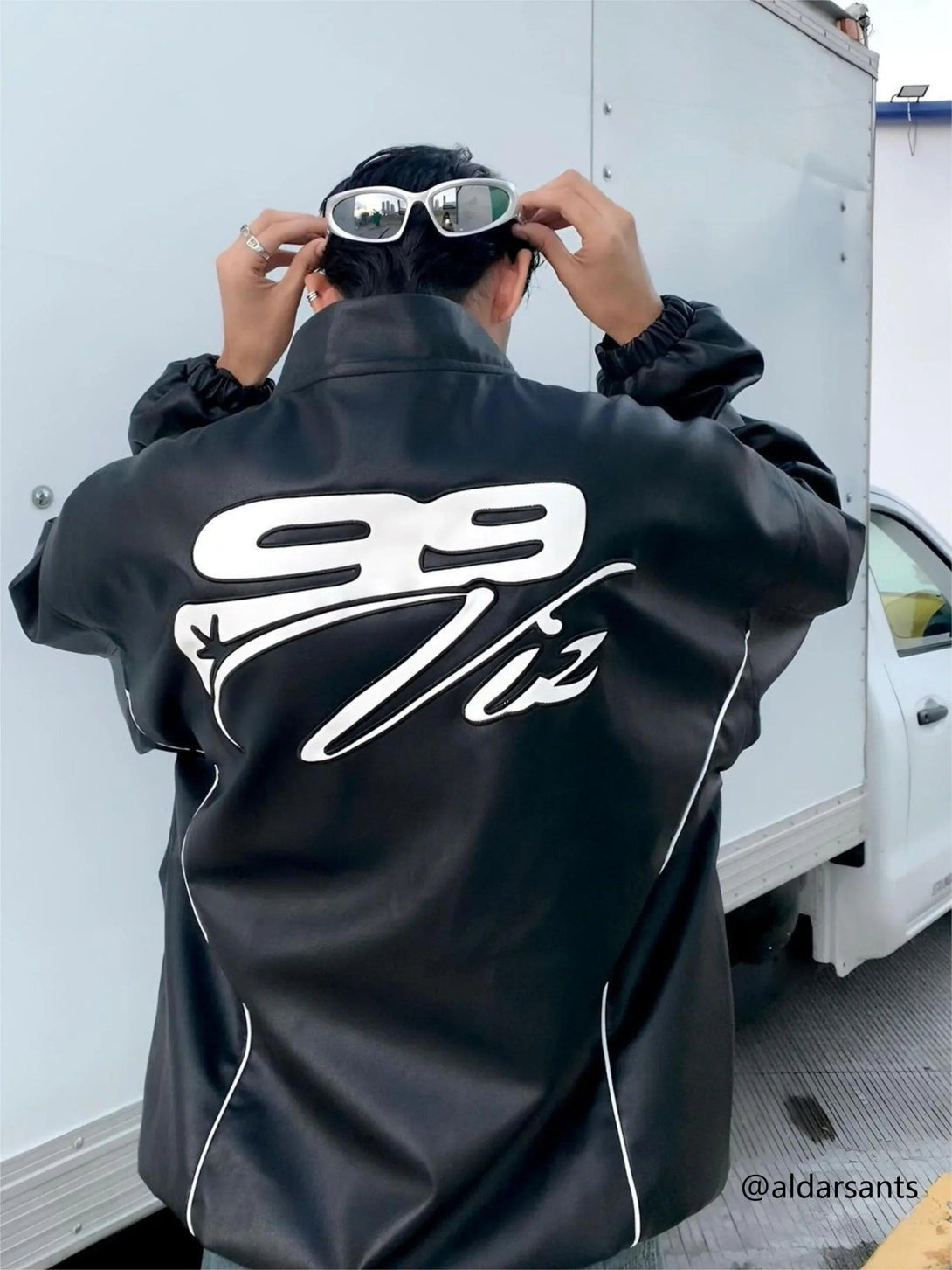 Back view of a TALISHKO PU motorcycle jacket with hip-hop street style graphics and stitching.
