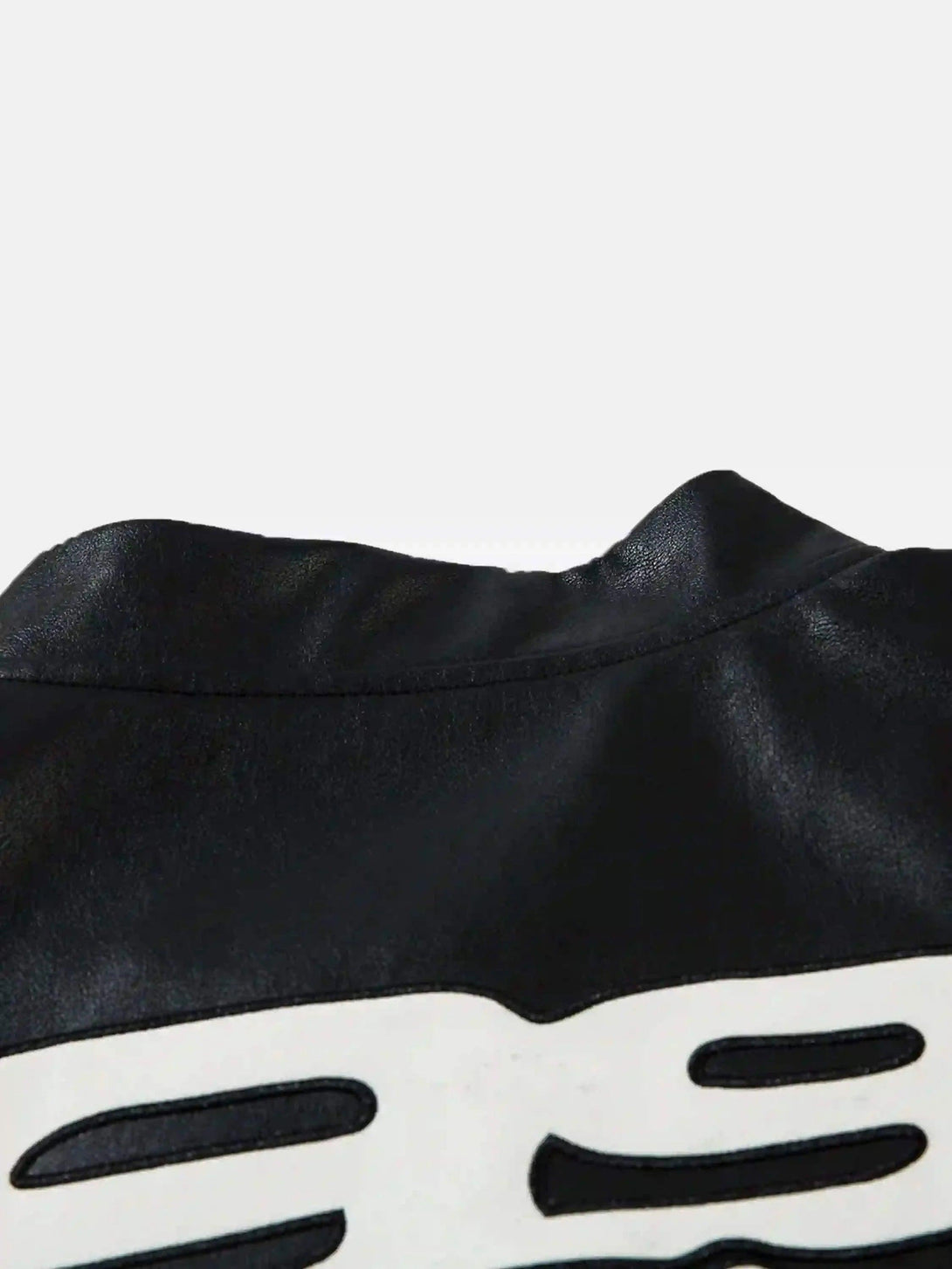 Intricate look at TALISHKO's black PU motorcycle jacket, highlighting stitching detail.
