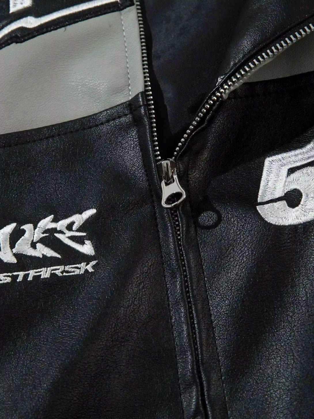 Zipper and stitching details on TALISHKO's hip-hop street style PU motorcycle jacket.
