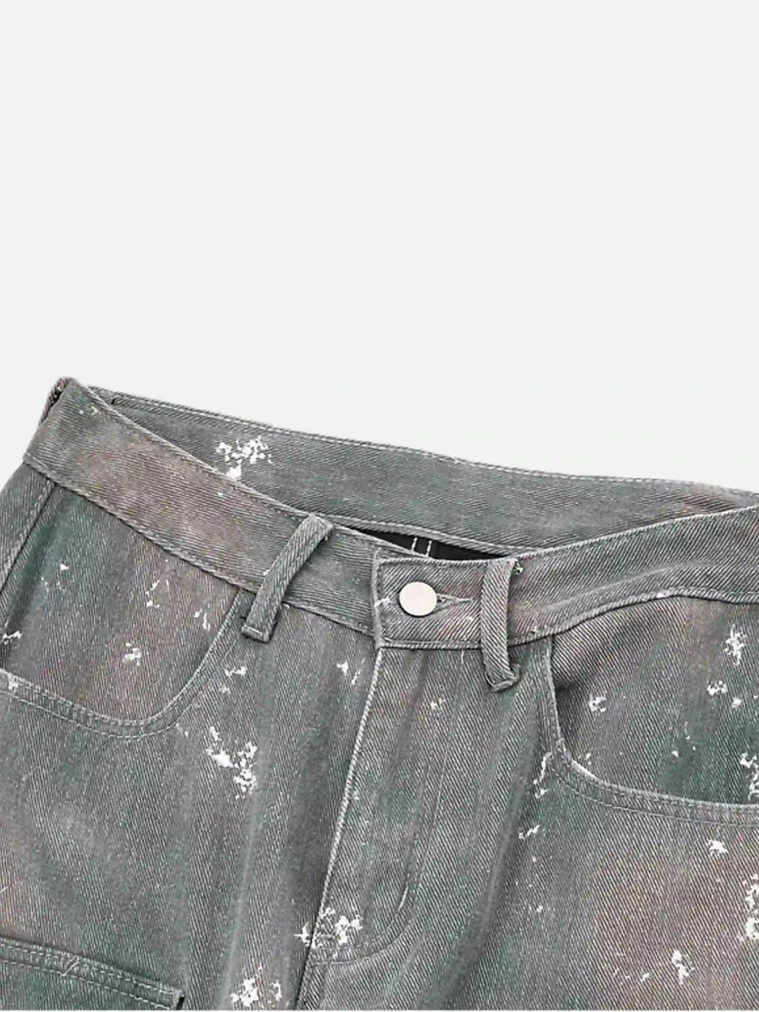 A close-up of TALISHKO ink-splashed jeans, highlighting the hip-hop-inspired design details.