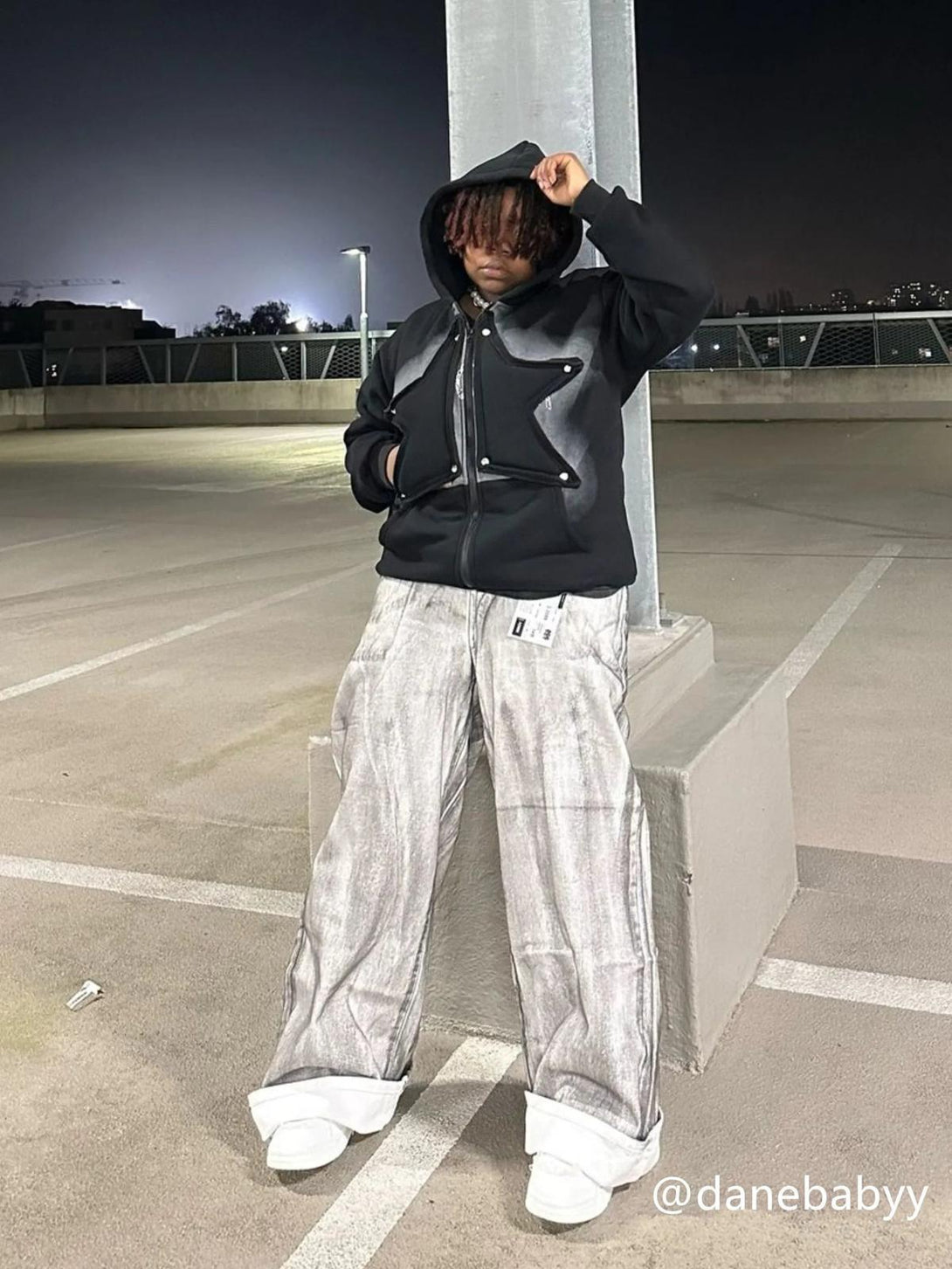 Street style vibes with TALISHKO's painted dirty jeans and hoodie ensemble, perfect for urban nights.