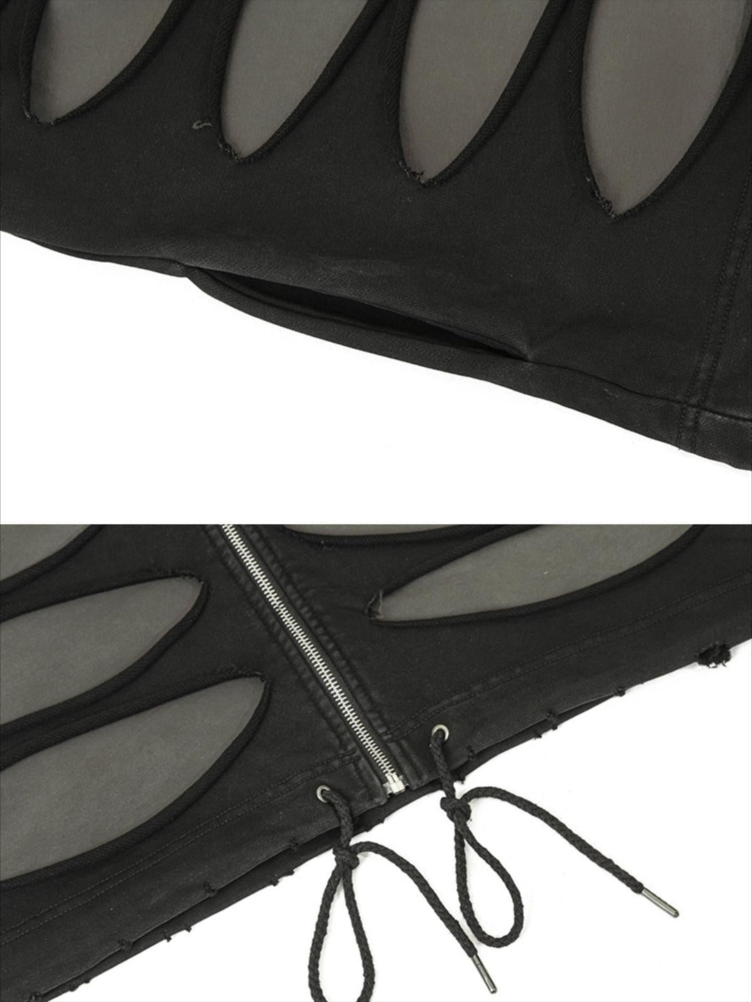 Intricate look at TALISHKO's black hoodie, highlighting cut-out details and zipper accents.