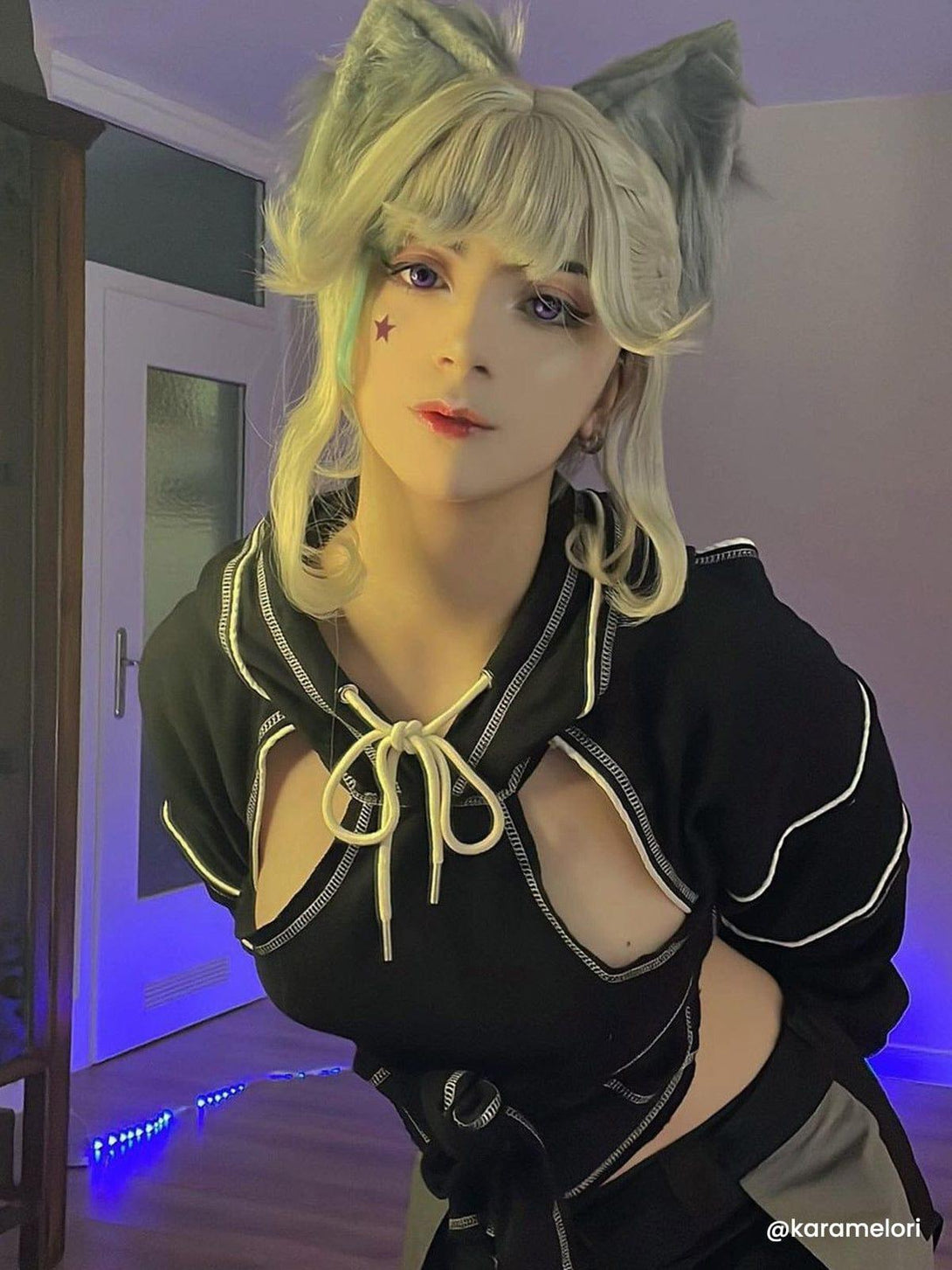 Model wearing TALISHKO's stylish hoodie with tie-bow and cut-out details, perfect for cosplay.