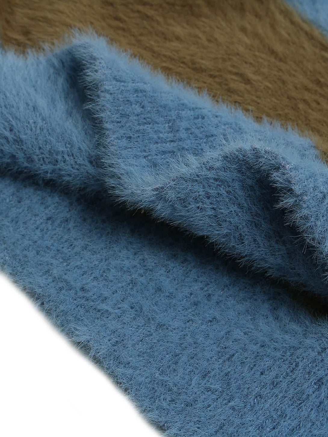 Zoomed-in texture of TALISHKO's blue and brown knit sweater, highlighting its plush material.