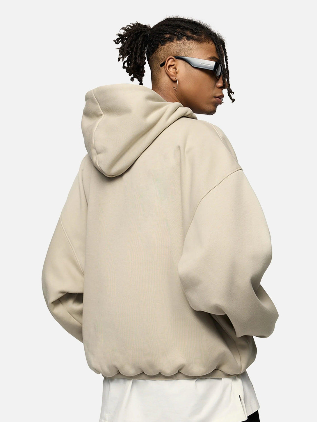 Rear view of a beige TALISHKO hoodie, showcasing its oversized fit and casual vibe.