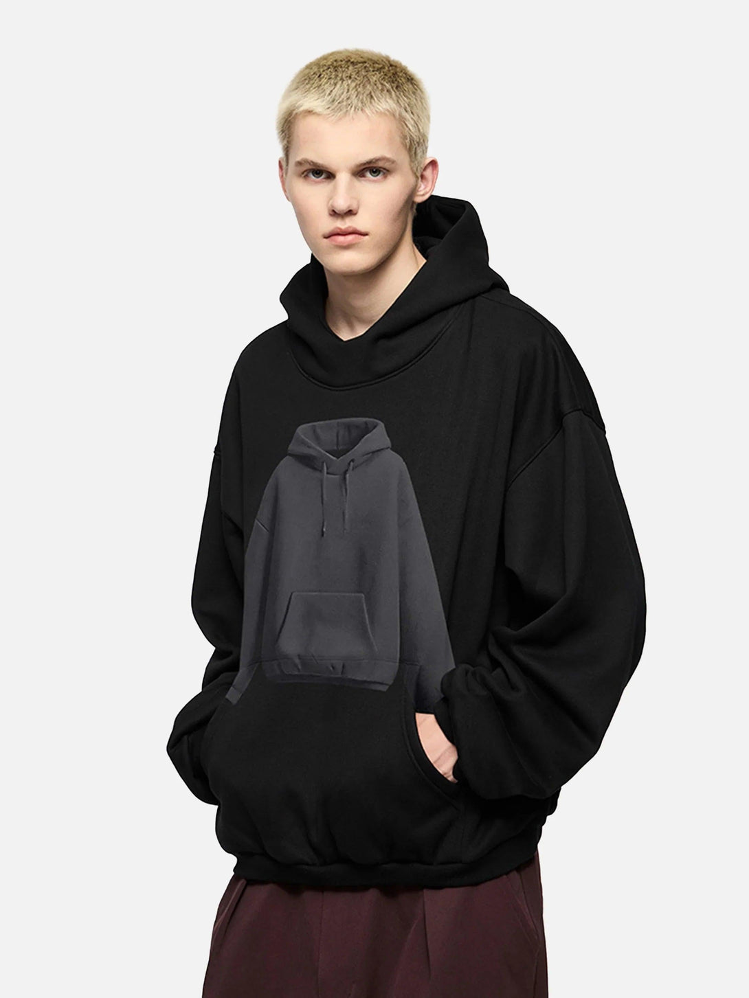 Model wearing a black TALISHKO hoodie with a unique hoodie pattern design.