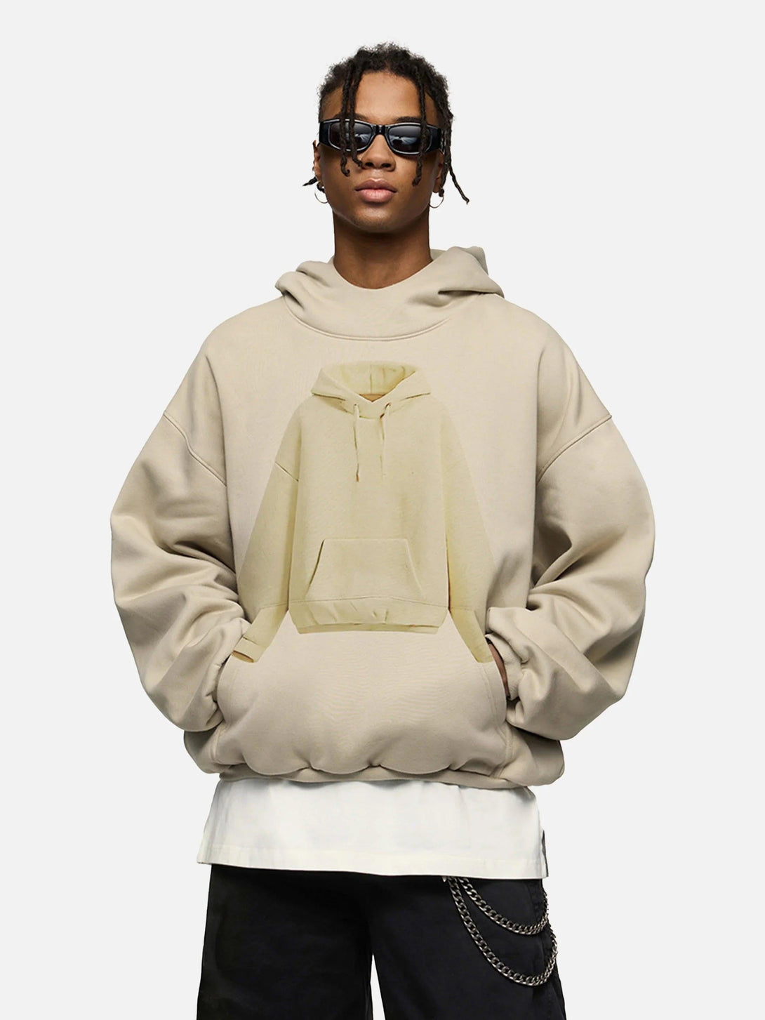 Model in a beige TALISHKO hoodie featuring a playful hoodie graphic on the front.