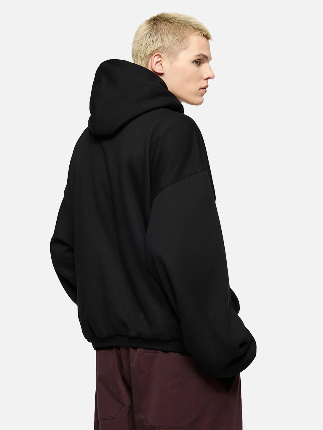 Rear view of a black TALISHKO hoodie, highlighting its relaxed fit and casual style.