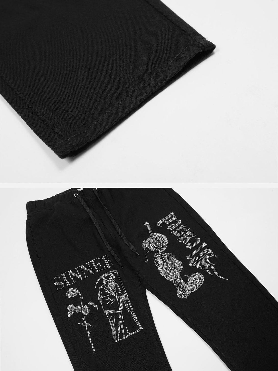 A detailed view of TALISHKO black pants highlighting intricate graphic designs and sleek stitching.