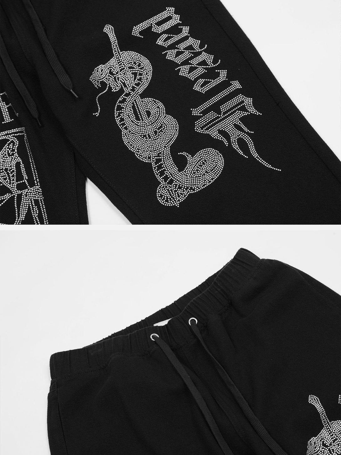 Intricate look at TALISHKO's black pants with diamond craft design and drawstring detail.