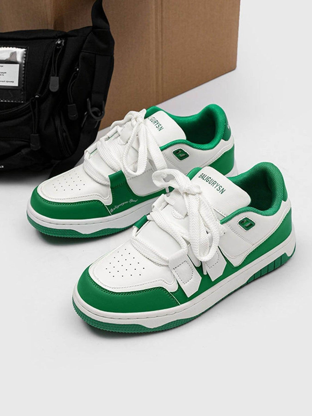 TALISHKO green and white sports board shoes, front view highlighting classic design.