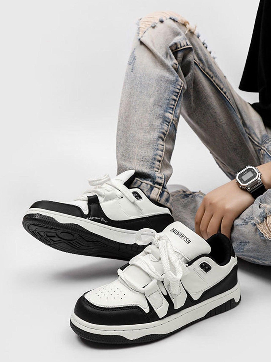 TALISHKO black and white board shoes paired with ripped jeans, showcasing casual street style.