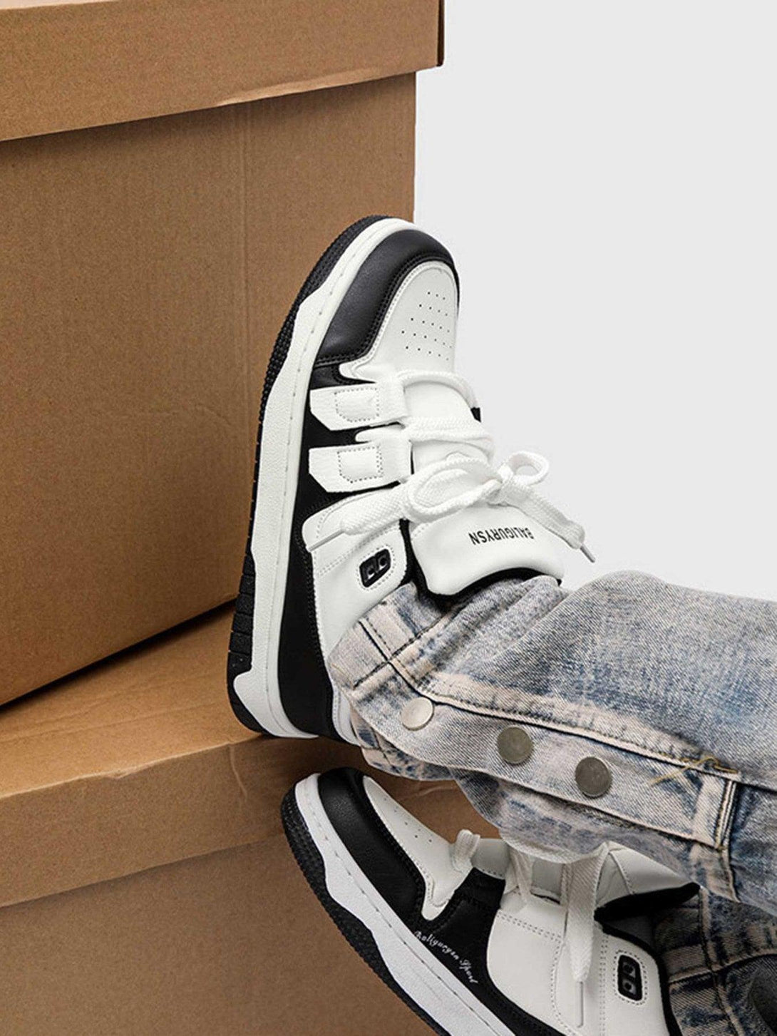 TALISHKO black and white board shoes styled with denim jeans, showcasing urban casual flair.