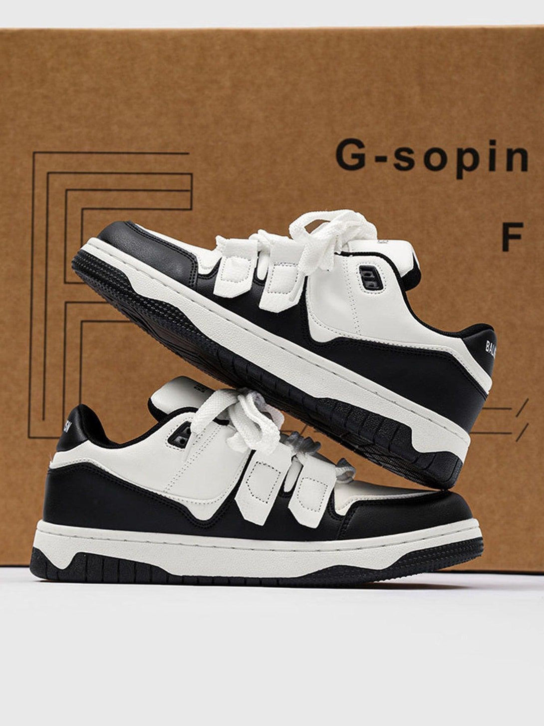 TALISHKO black and white board shoes, side view highlighting sporty casual design.