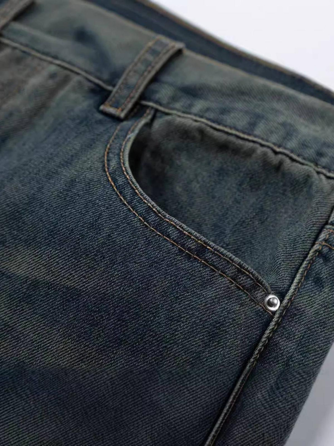 A detailed view of TALISHKO jeans pocket, showcasing sturdy stitching and classic denim texture.