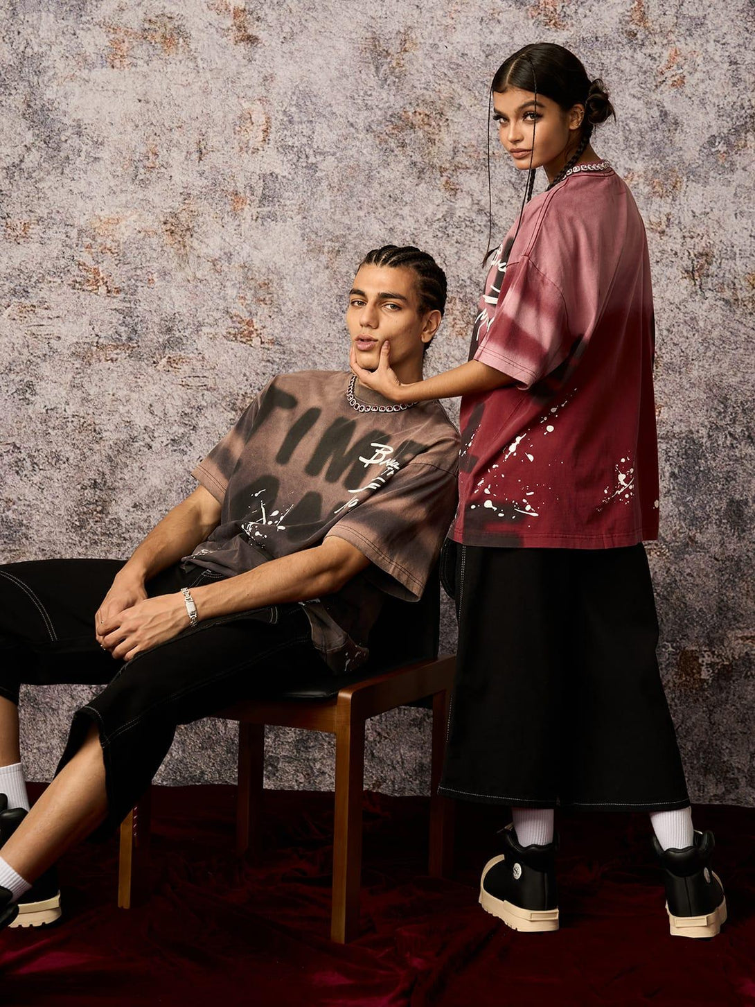 Models wearing TALISHKO ink splash letter print T-shirts, highlighting edgy urban streetwear.