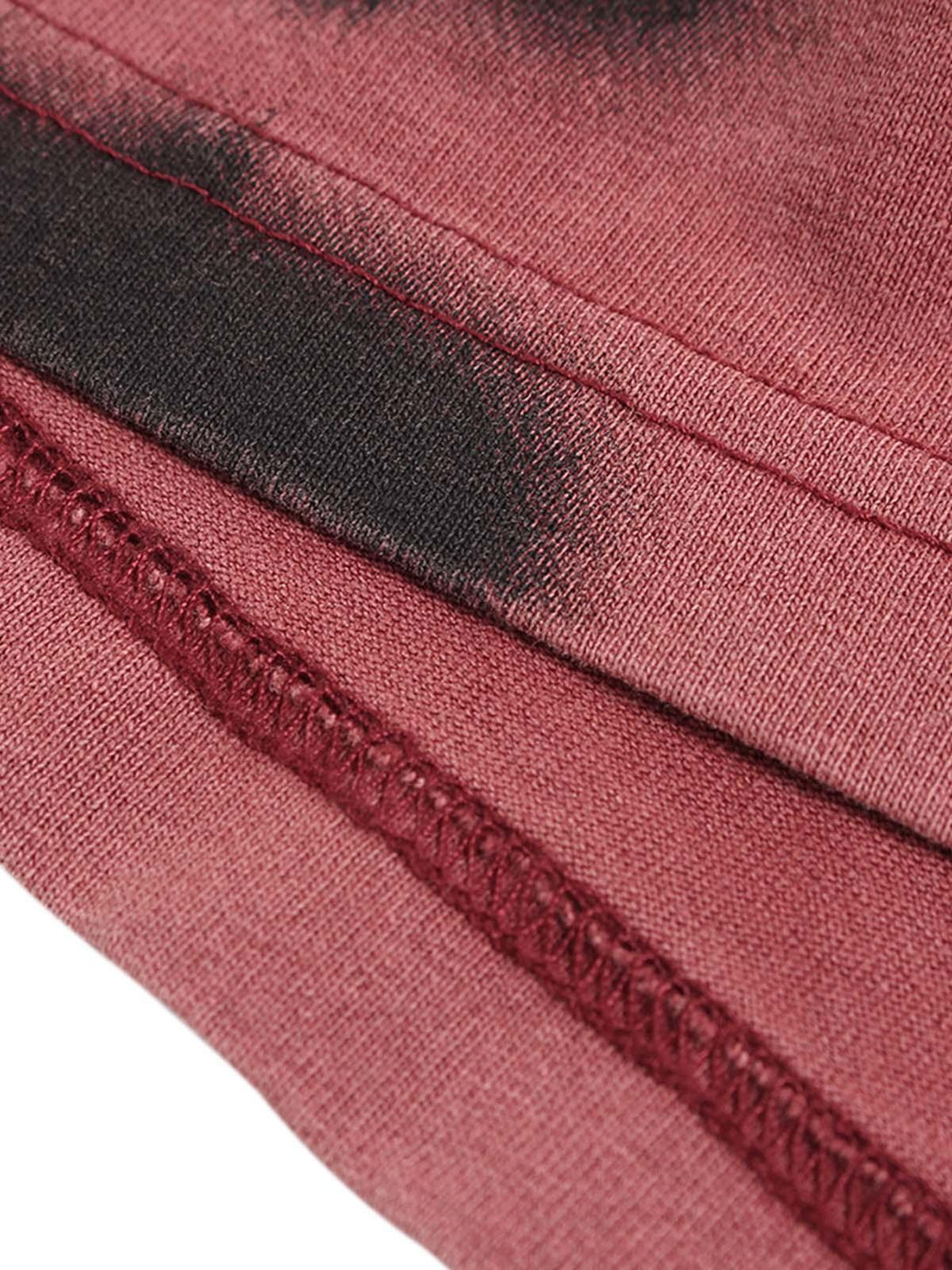 "Detailed stitching and fabric texture of TALISHKO ink splash letter print T-shirt in deep red."