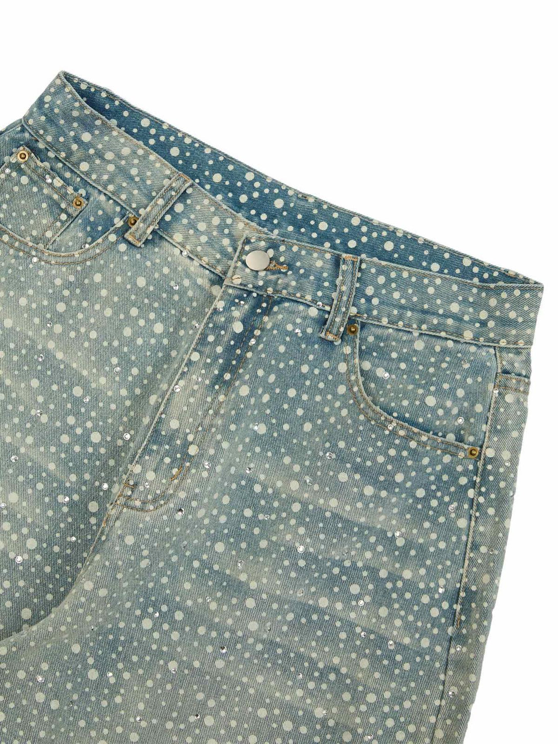 A close-up of TALISHKO baggy jeans showcasing ink-splashed rhinestones on the front pocket.