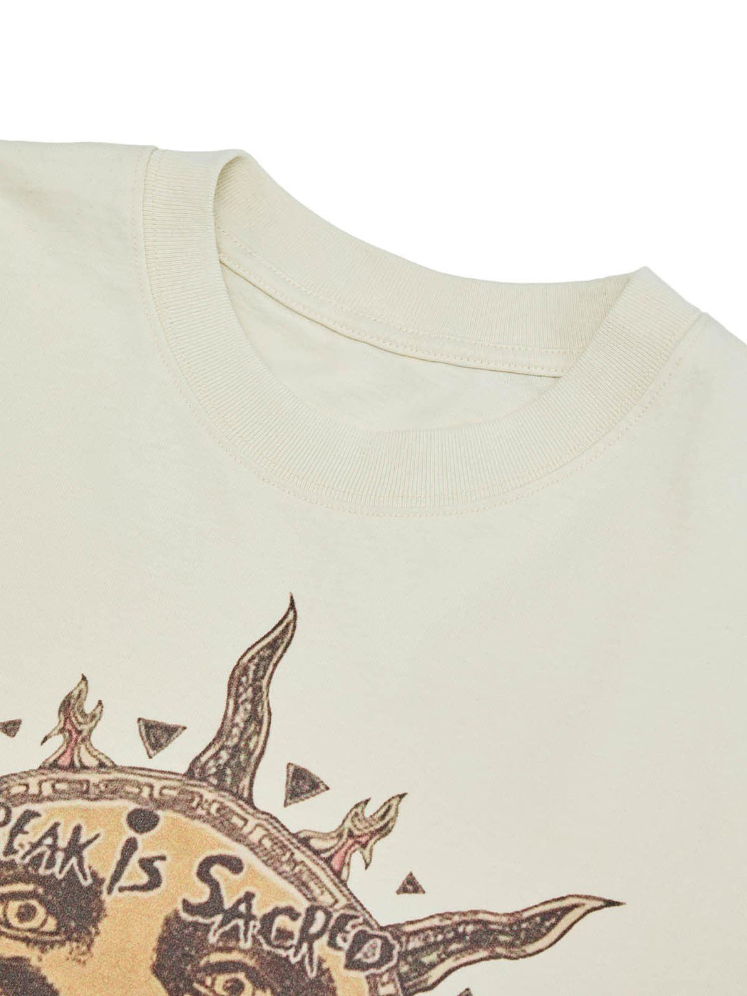 A detailed view of the TALISHKO T-shirt's neckline, showcasing intricate sun god artwork.