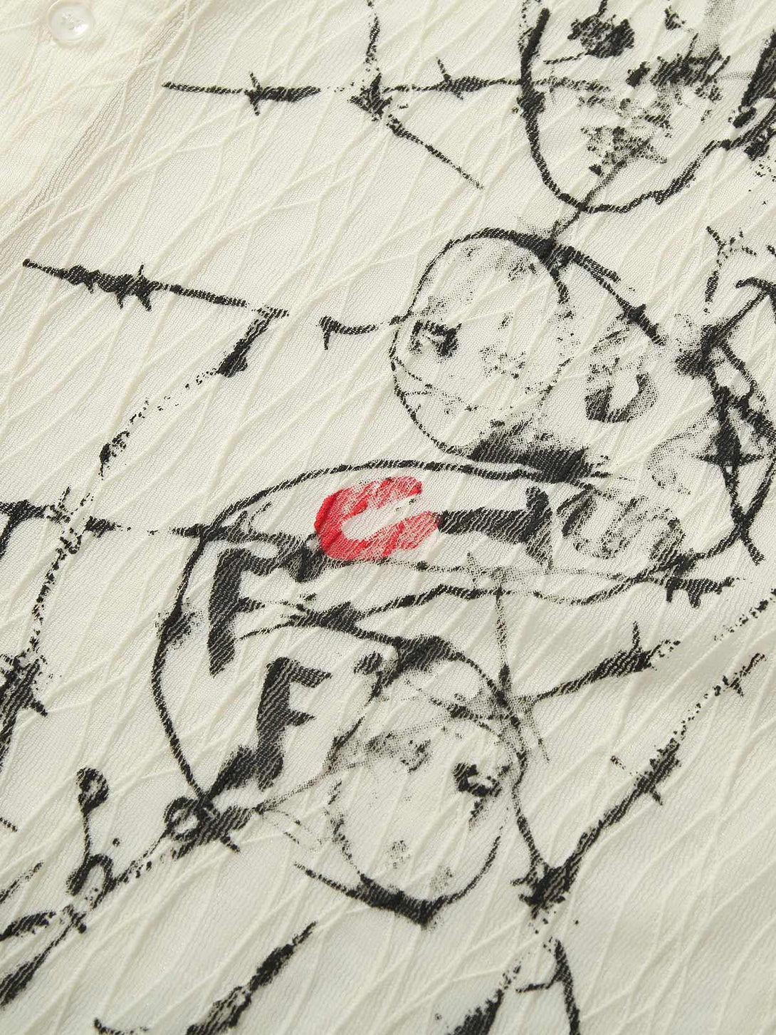 Intricate look at the pleated print design on TALISHKO's shirt, highlighting artistic details.
