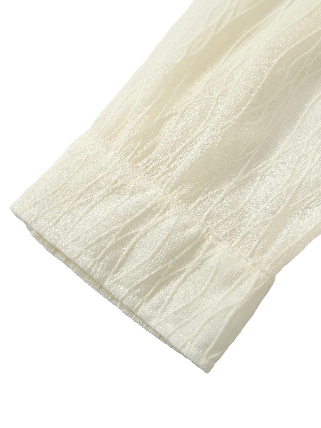 A detailed view of the sleeve's pleated texture on TALISHKO's shirt, showcasing its elegance.