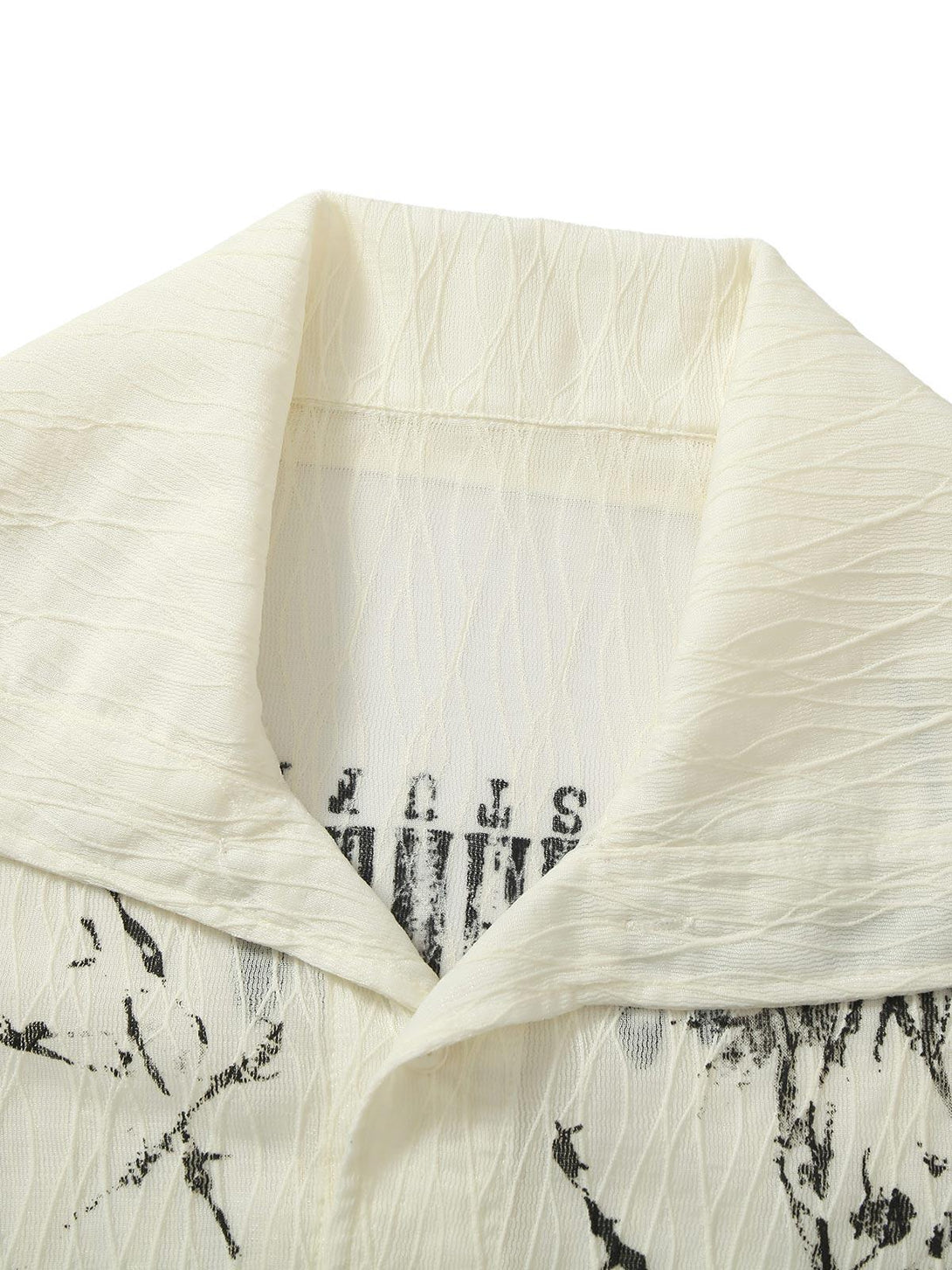 Intricate collar details of TALISHKO's pleated print shirt, featuring unique textures and designs.