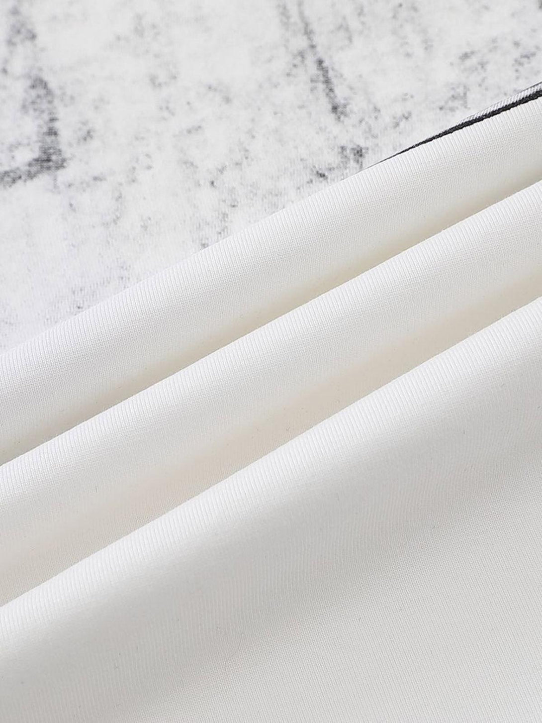 Zoomed-in texture of TALISHKO's graphic T-shirt fabric, showcasing intricate design details.