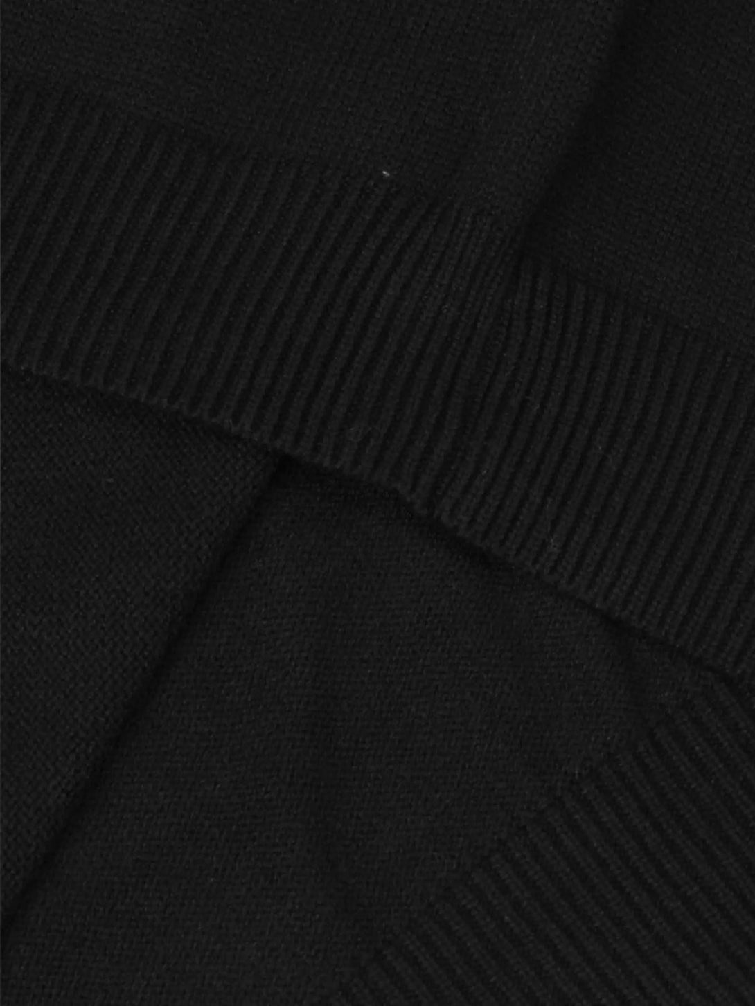 A close-up of the soft black texture and ribbed detailing on a TALISHKO crewneck sweater.