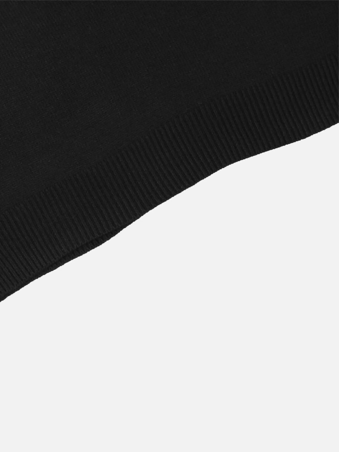 Intricate look at the black ribbed hem detail on a TALISHKO crewneck sweater.