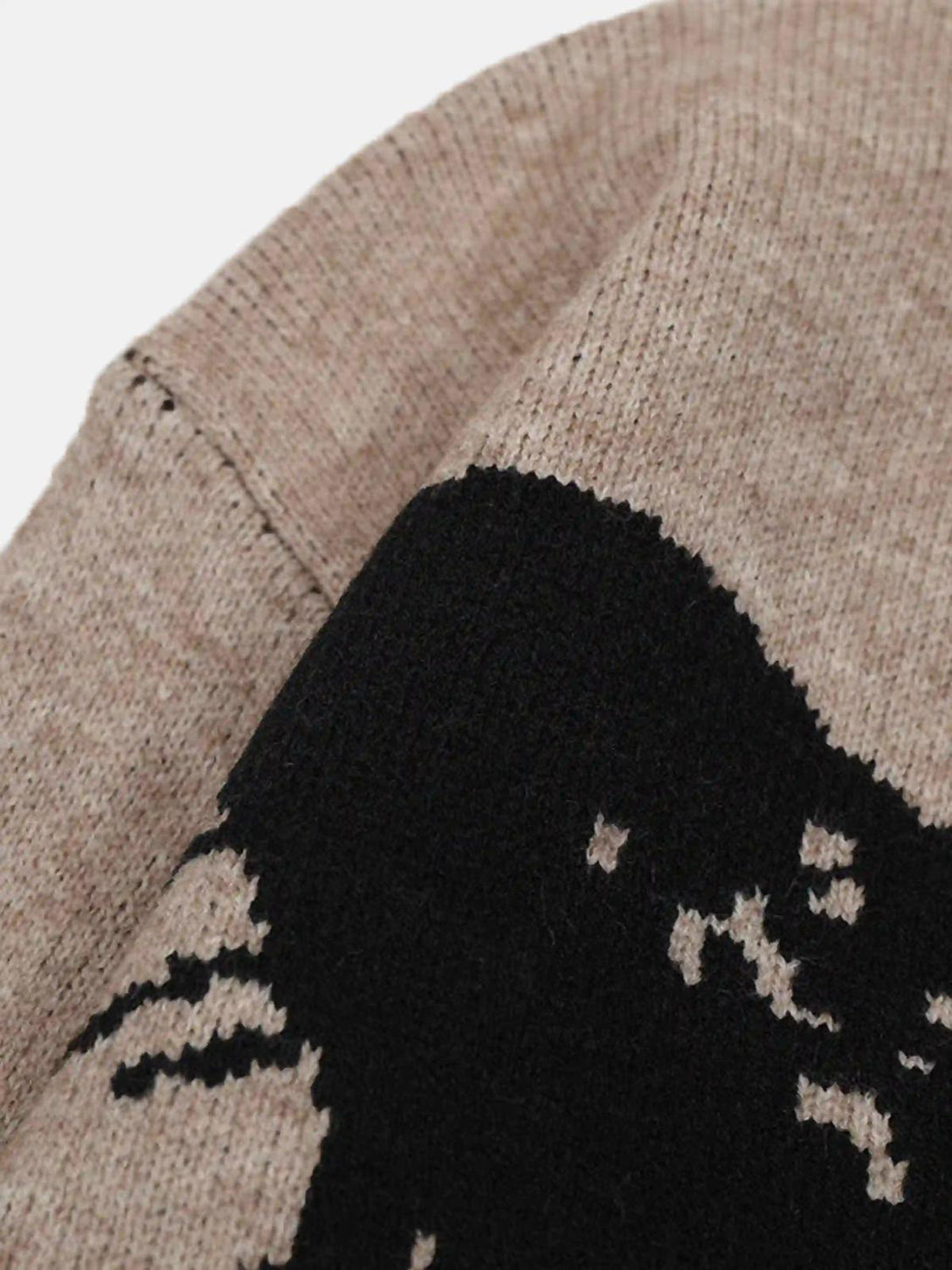 Detailed fabric and stitching of TALISHKO jacquard butterfly sweater in beige and black.