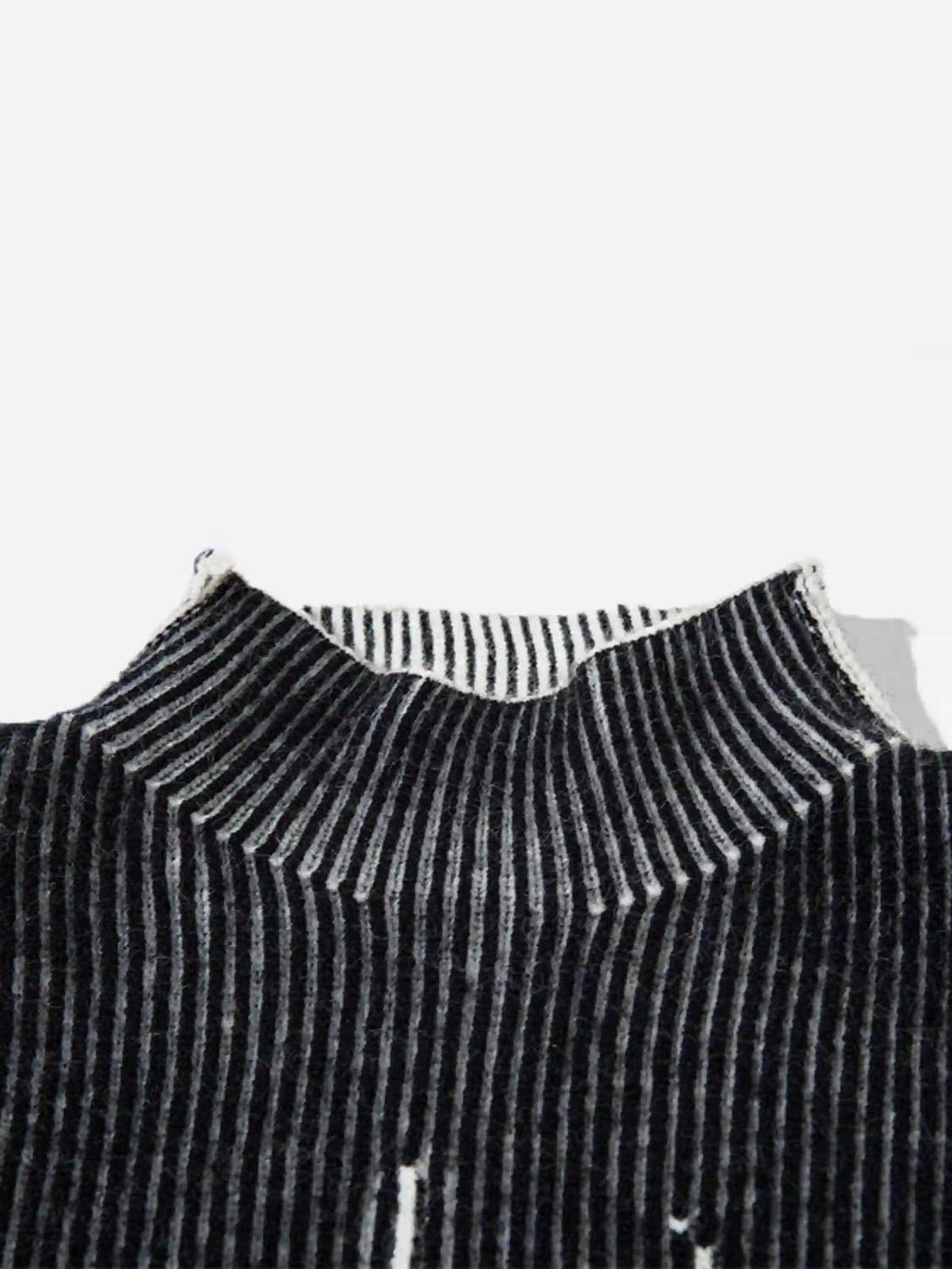 A detailed view of TALISHKO jacquard half turtleneck sweater, highlighting its striped texture.