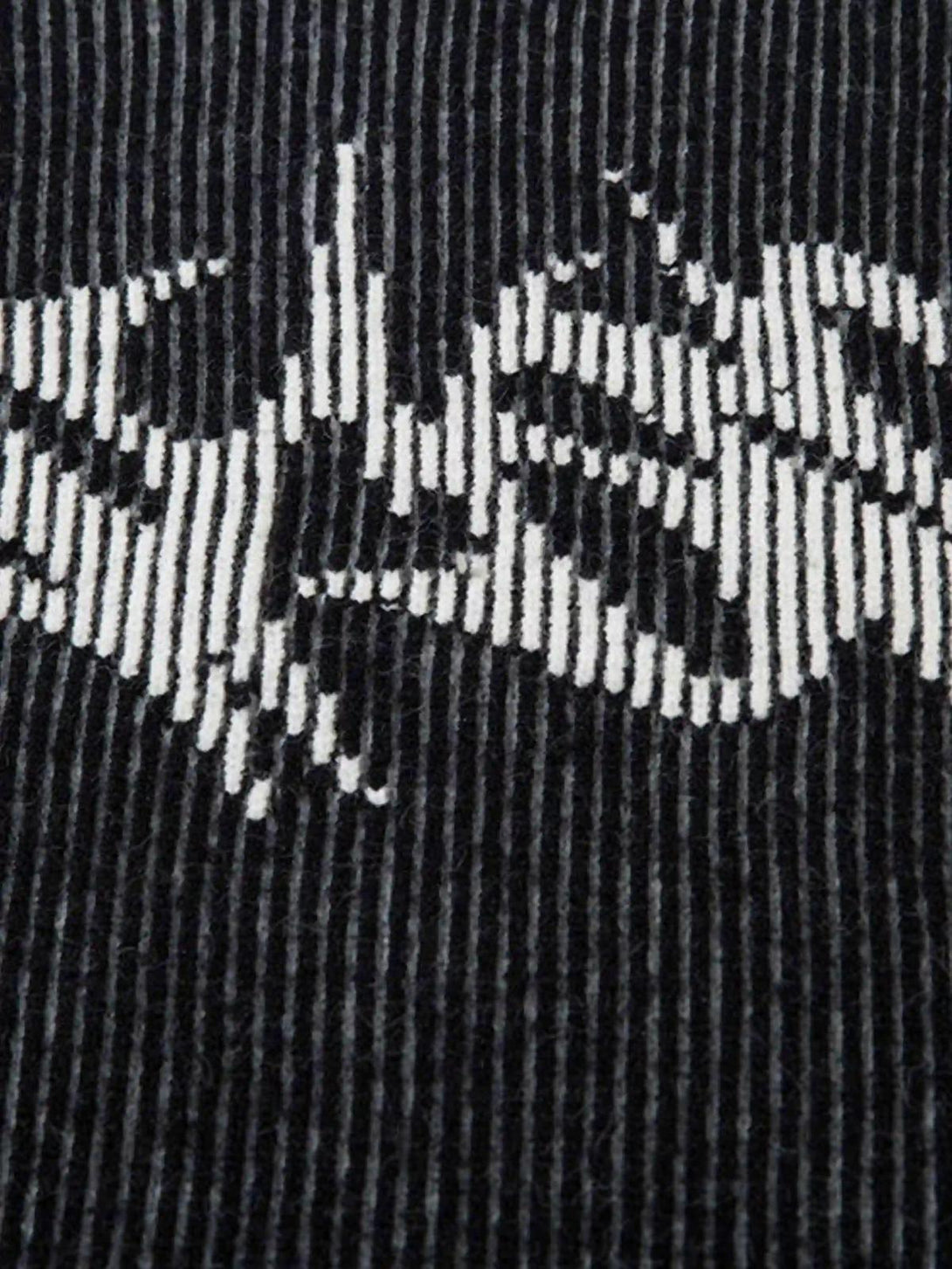 Intricate look at TALISHKO jacquard half turtleneck sweater, highlighting its textured pattern.